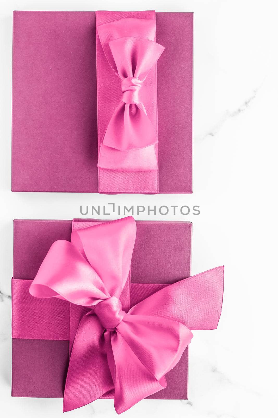 Birthday, wedding and girly branding concept - Pink gift box with silk bow on marble background, girl baby shower present and glamour fashion gift for luxury beauty brand, holiday flatlay art design