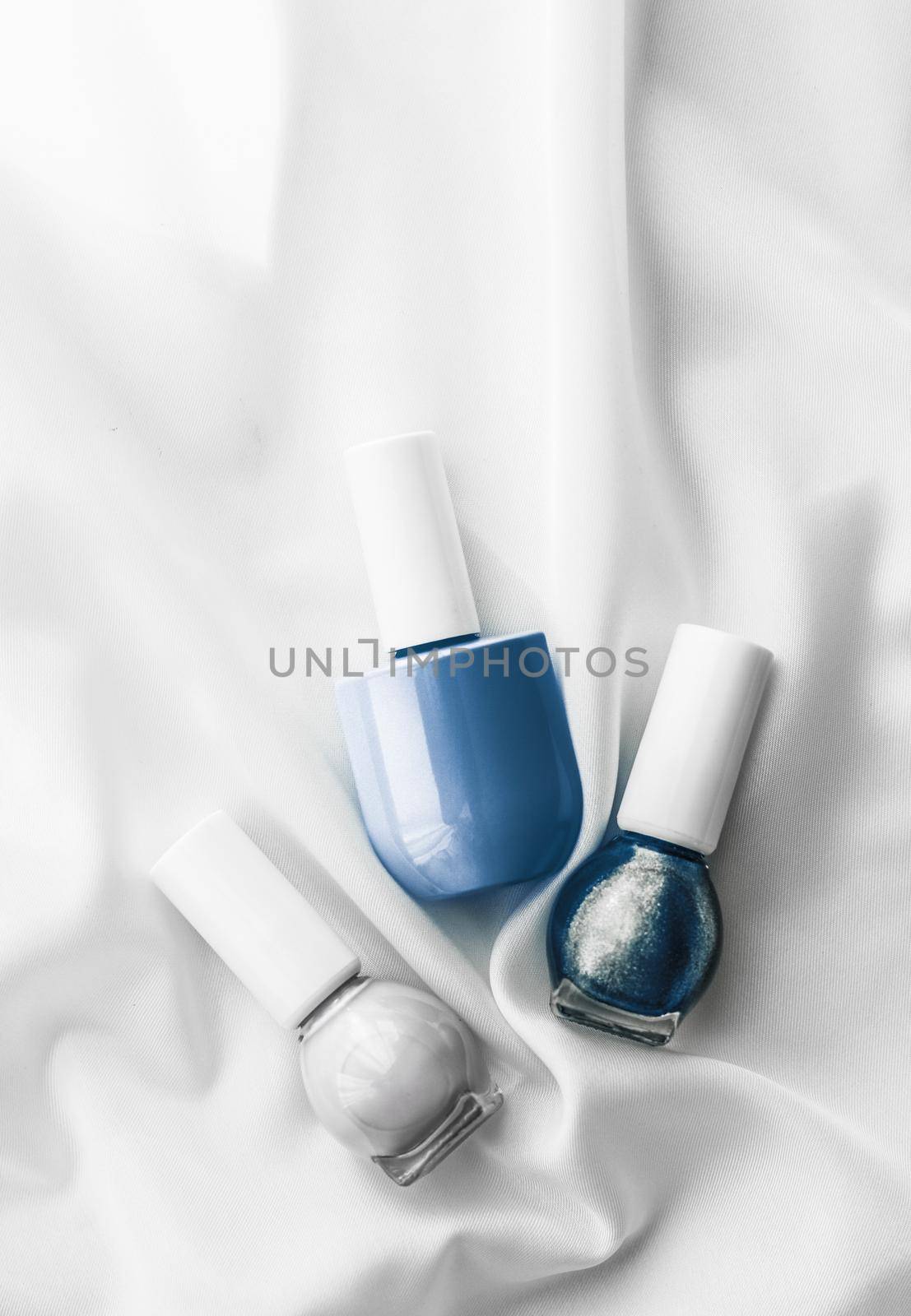 Cosmetic branding, salon and glamour concept - Nail polish bottles on silk background, french manicure products and nailpolish make-up cosmetics for luxury beauty brand and holiday flatlay art design