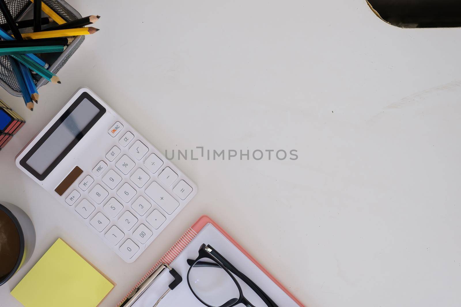 Modern white wooden desk table calculator and business tools office. top view.