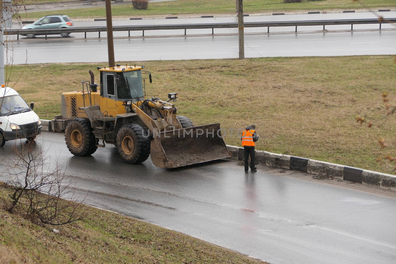 It's a clean city. People, workers clean the roads. Roadworks and road cleaning. High quality photo