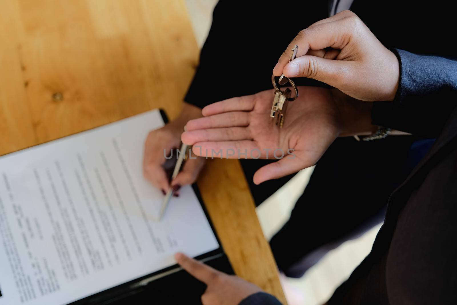 Real estate agent offer hand for customer sign agreement contract signature for buy or sell house. Real estate concept contact agreement concept.