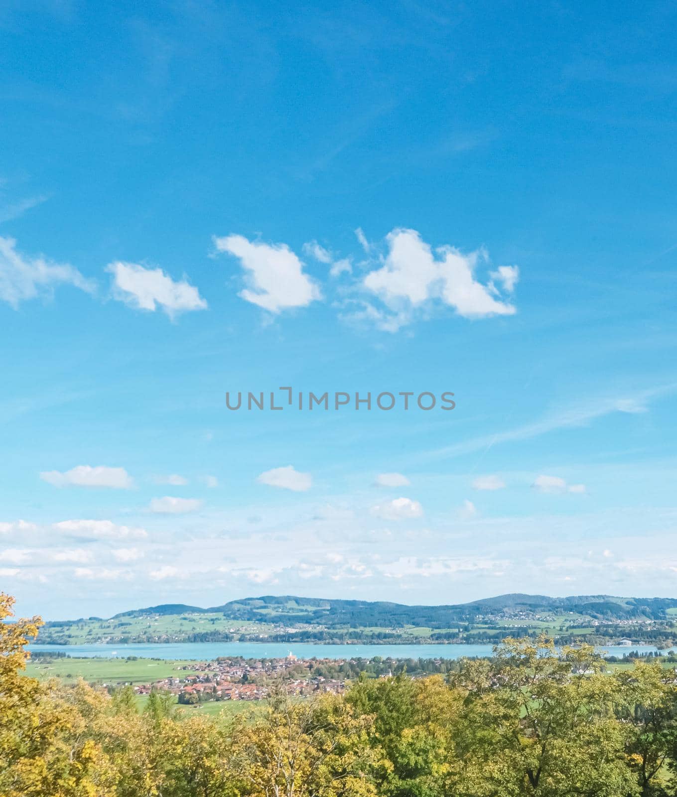 Beautiful nature of European Alps, landscape view of alpine mountains, lake and village on a sunny day, travel and destination scenery