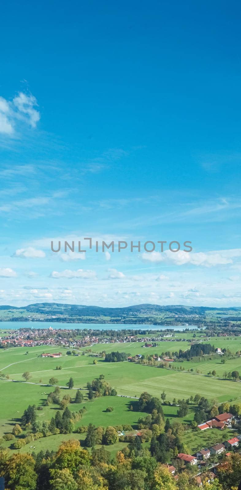 Beautiful nature of European Alps, landscape view of alpine mountains, lake and village on a sunny day, travel and destination scenery