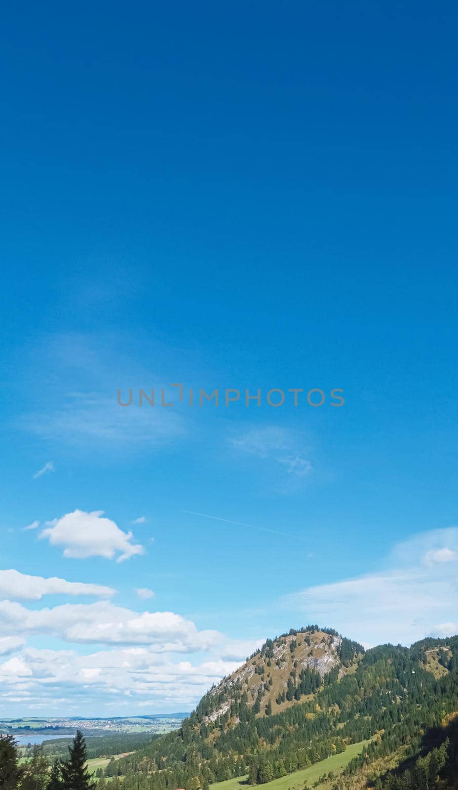 Beautiful nature of European Alps, landscape view of alpine mountains, lake and village on a sunny day, travel and destination scenery