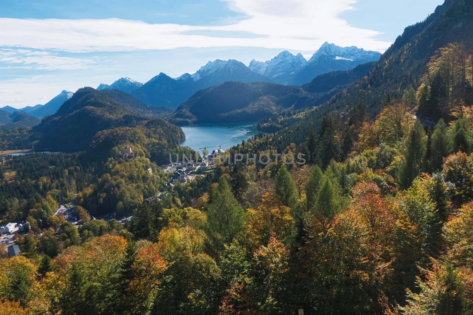 Beautiful nature of European Alps, landscape view of alpine mountains, lake and village on a sunny day, travel and destination scenery