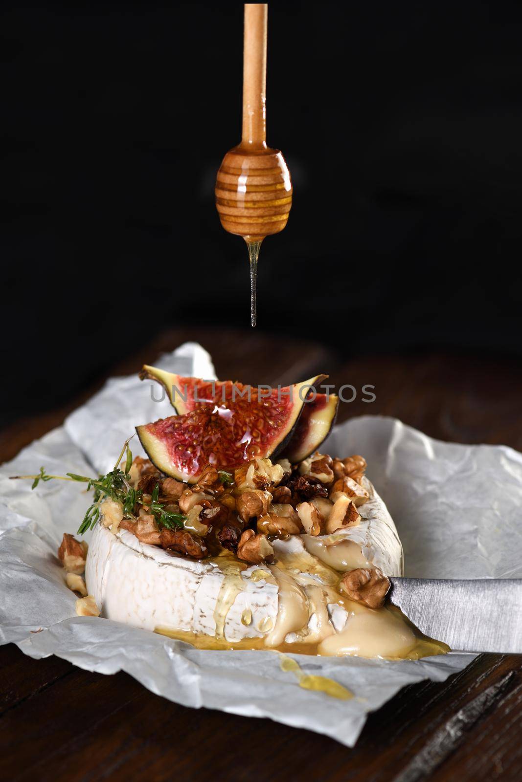 Baked brie cheese with nuts and honey by Apolonia