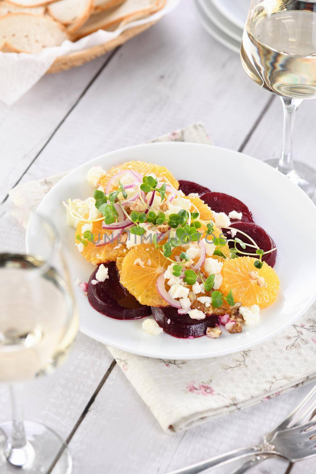 Orange salad with baked beetroot, goat cheese, microgreens and nuts. Perfect as a side dish or as a light lunch for a brunch or dinner.