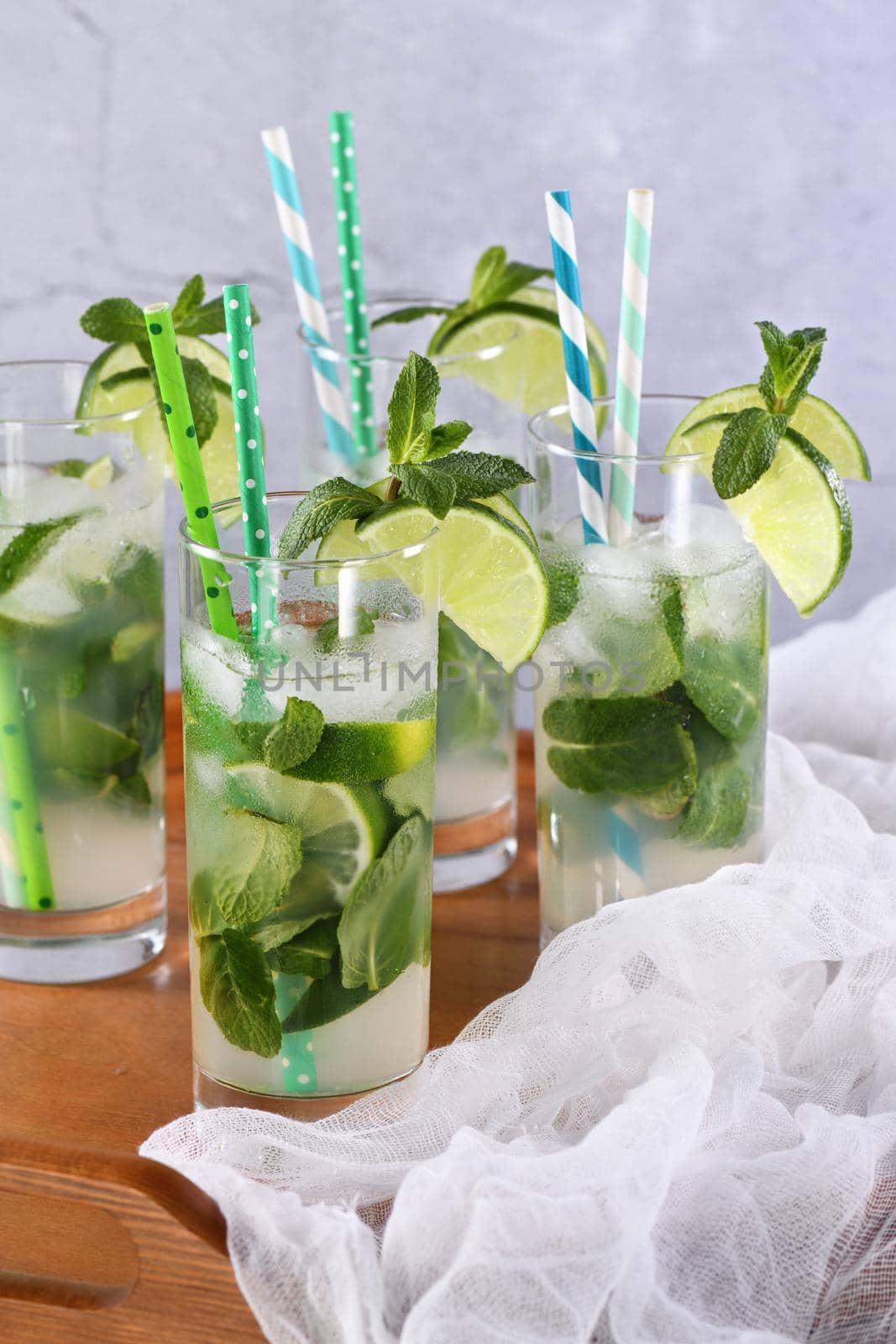 Refreshing infused water with cucumber, mint and lime. Summer drink cocktail lemonade. Healthy drink and detox concept