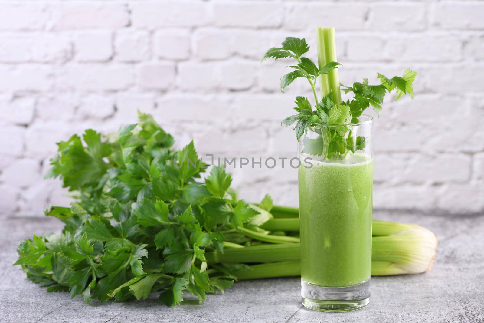 A glass of freshly made celery smoothie. A detox drink for those who care about health.