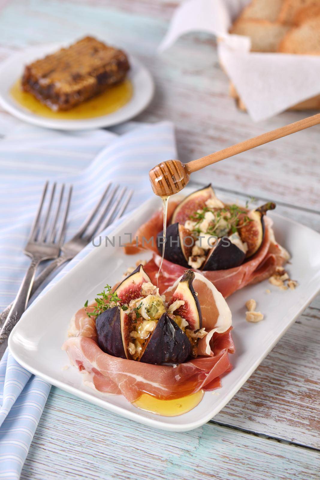 Figs stuffed with blue cheese, wrapped in Parma ham, drizzled with honey