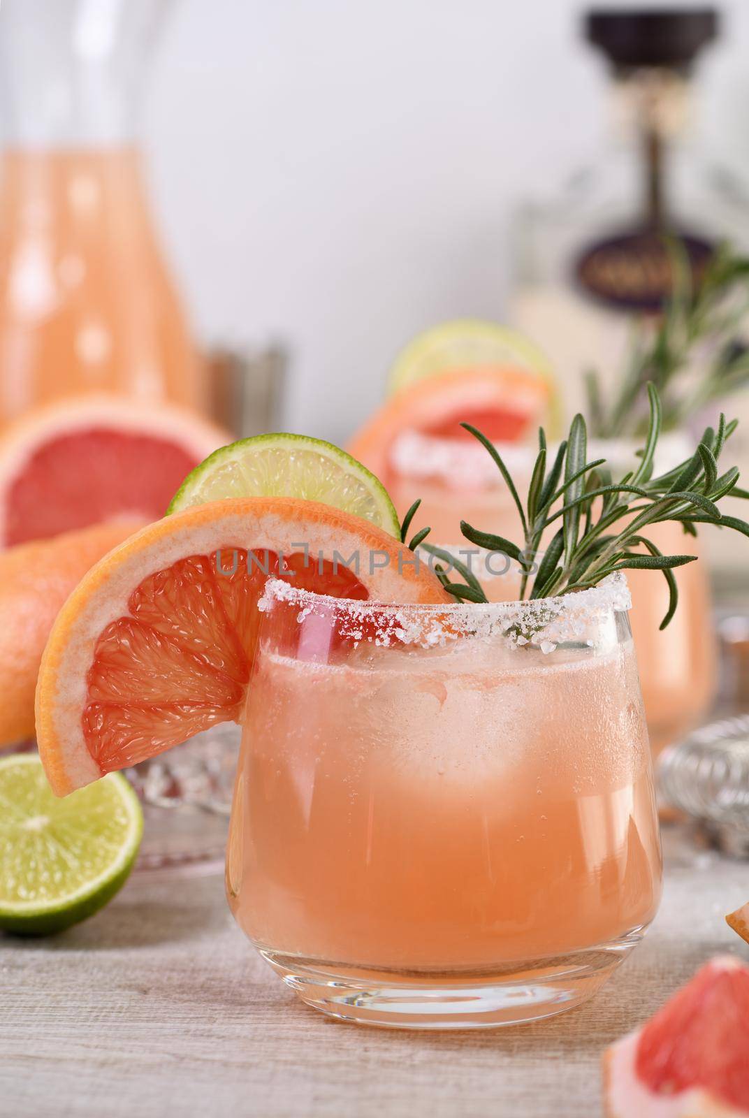 Cocktail pink Palomas fresh lime and rosemary combined with fresh grapefruit juice and tequila. A festive drink is ideal for brunch, parties and holidays.