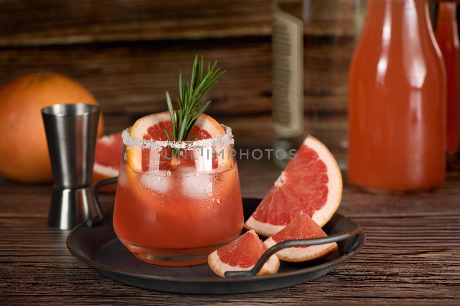 Cocktail tequila fresh grapefruit juice combined and rosemary. A festive drink is ideal for brunch, parties and holidays.