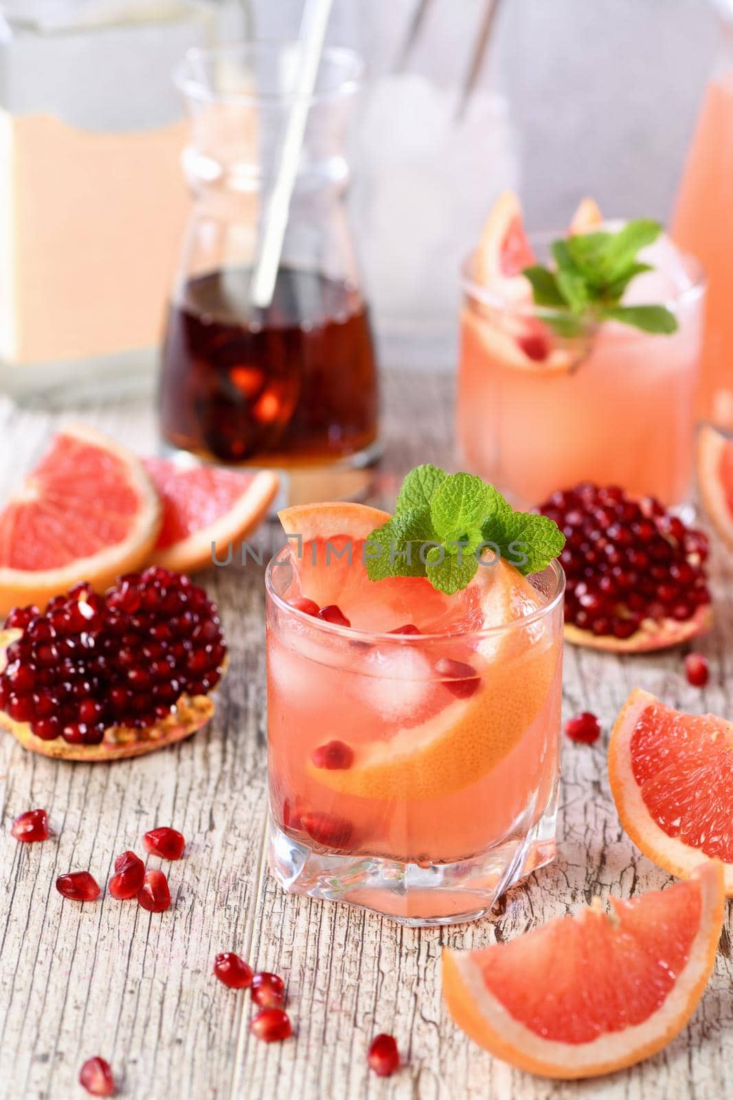 Tequila cocktail with pomegranate and grapefruit juice, tinted with the aroma of a fresh sprig of mint