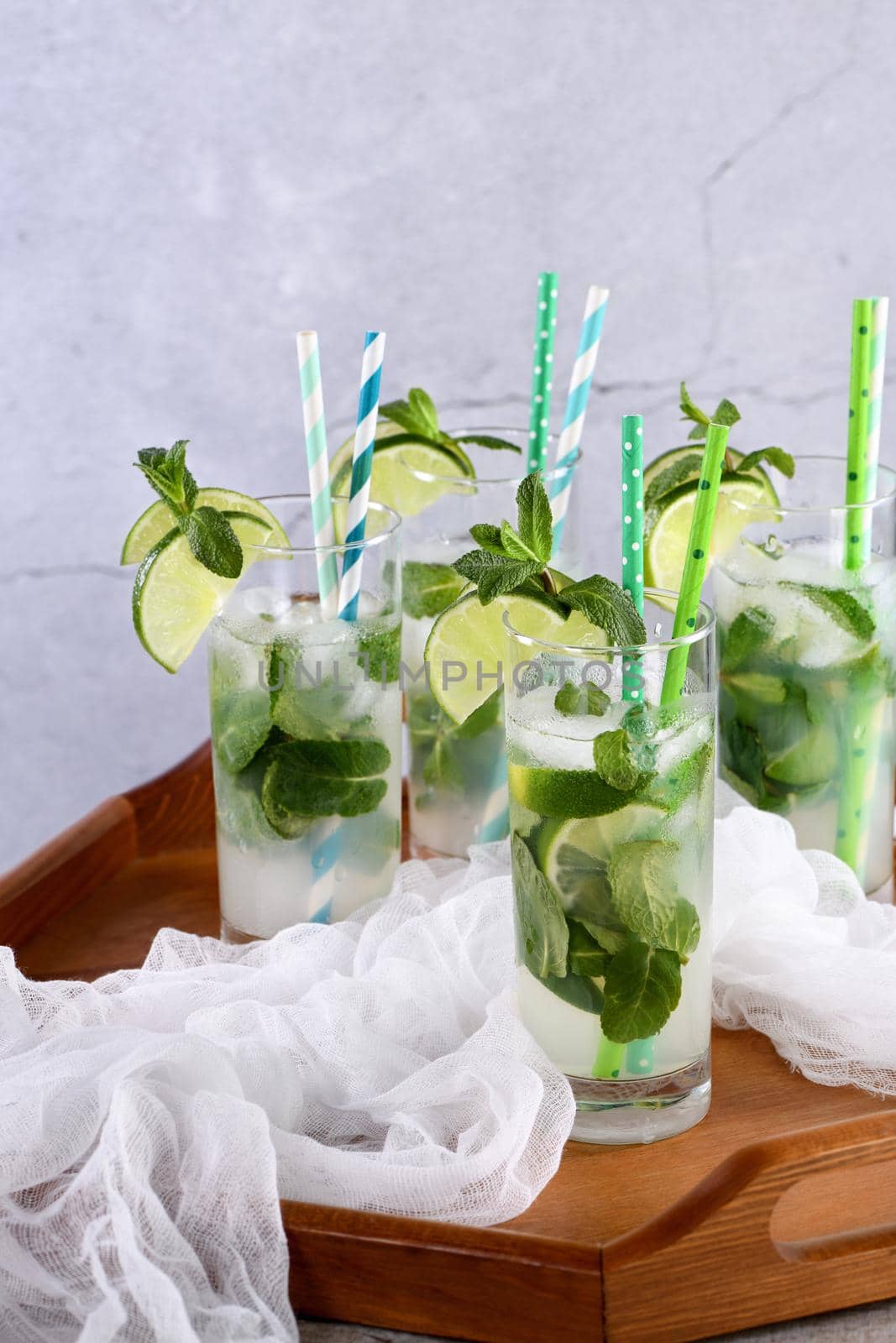 Refreshing infused water with cucumber, mint and lime. Summer drink cocktail lemonade. Healthy drink and detox concept