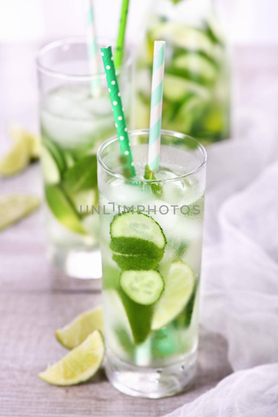 Refreshing  infused  water with cucumber, mint and lime . Summer beverage cocktail lemonade. Healthy drink and detox concept.   