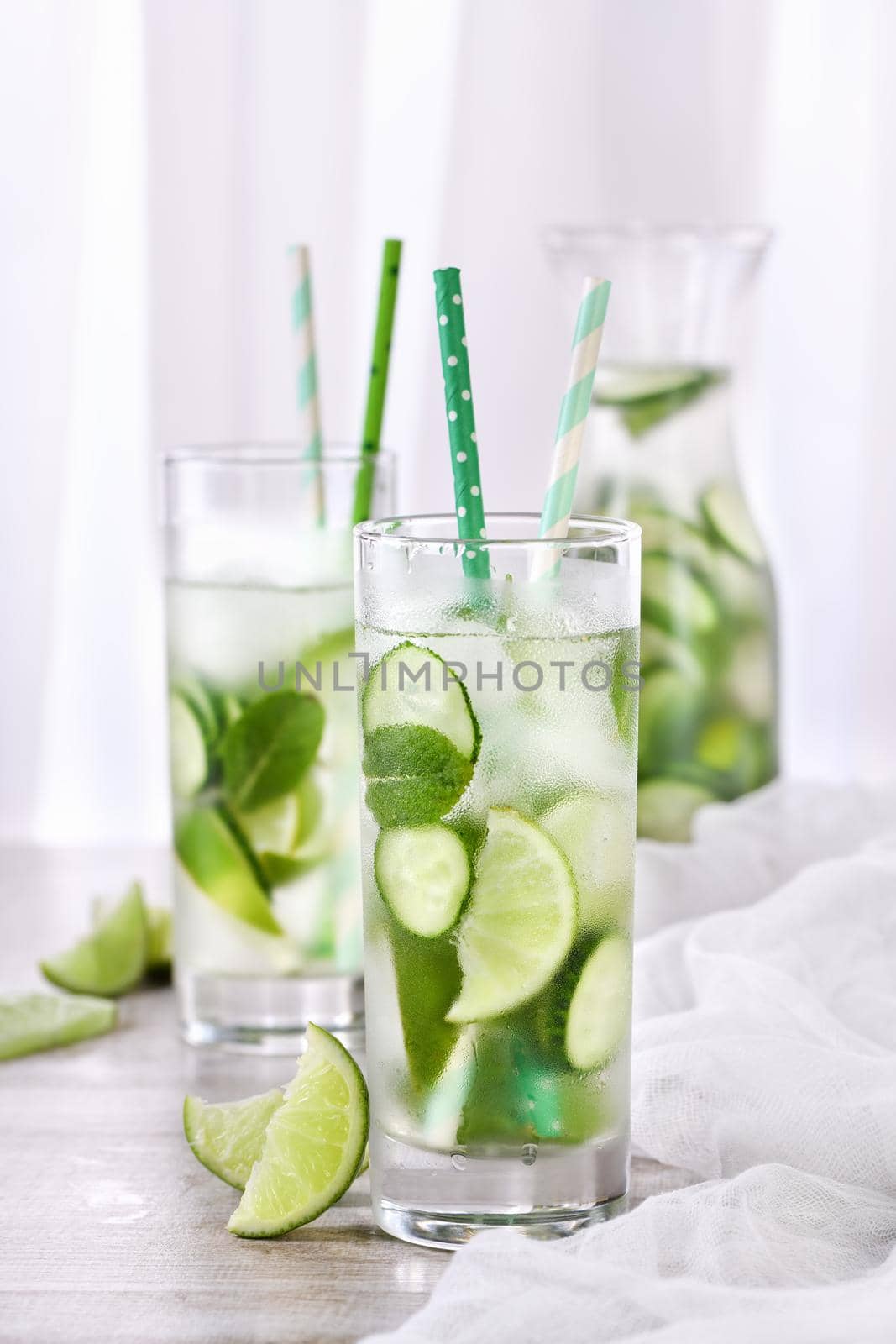 Refreshing  infused  water with cucumber, mint and lime . Summer beverage cocktail lemonade. Healthy drink and detox concept.   