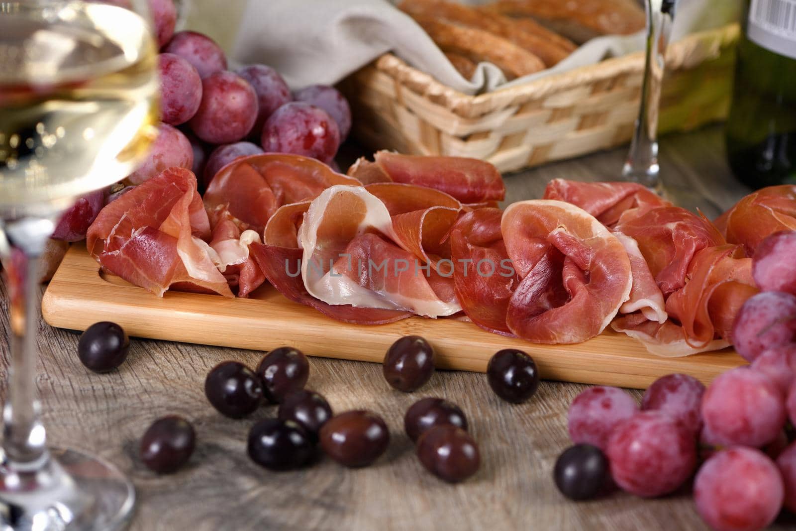 Antipasto. Wine set   snack sun-dried ham  jamon with grapes and olives