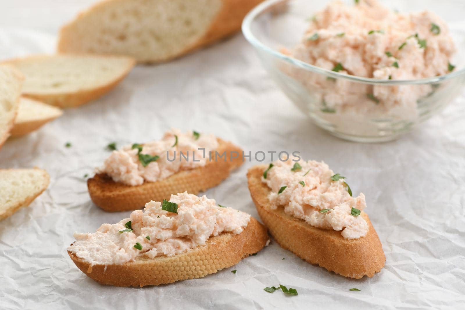  toasted sliced bread anointed pate  salmon with soft cheese and herb on paper