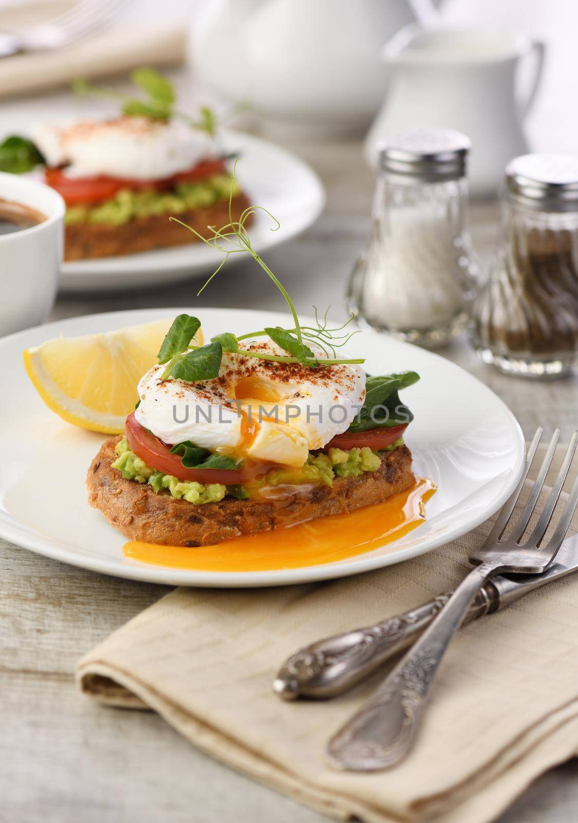  Breakfast. Best Eggs Benedict on a slice of toasted cereal bread with guacamole and spinach