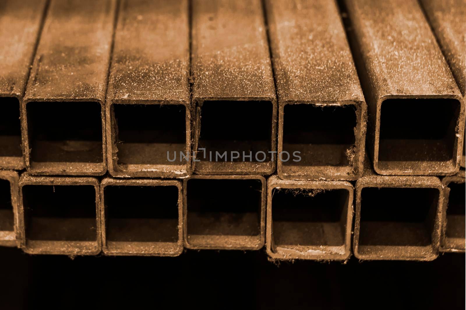 Square iron pipes. Side view, indoors horizontal shot. by Essffes