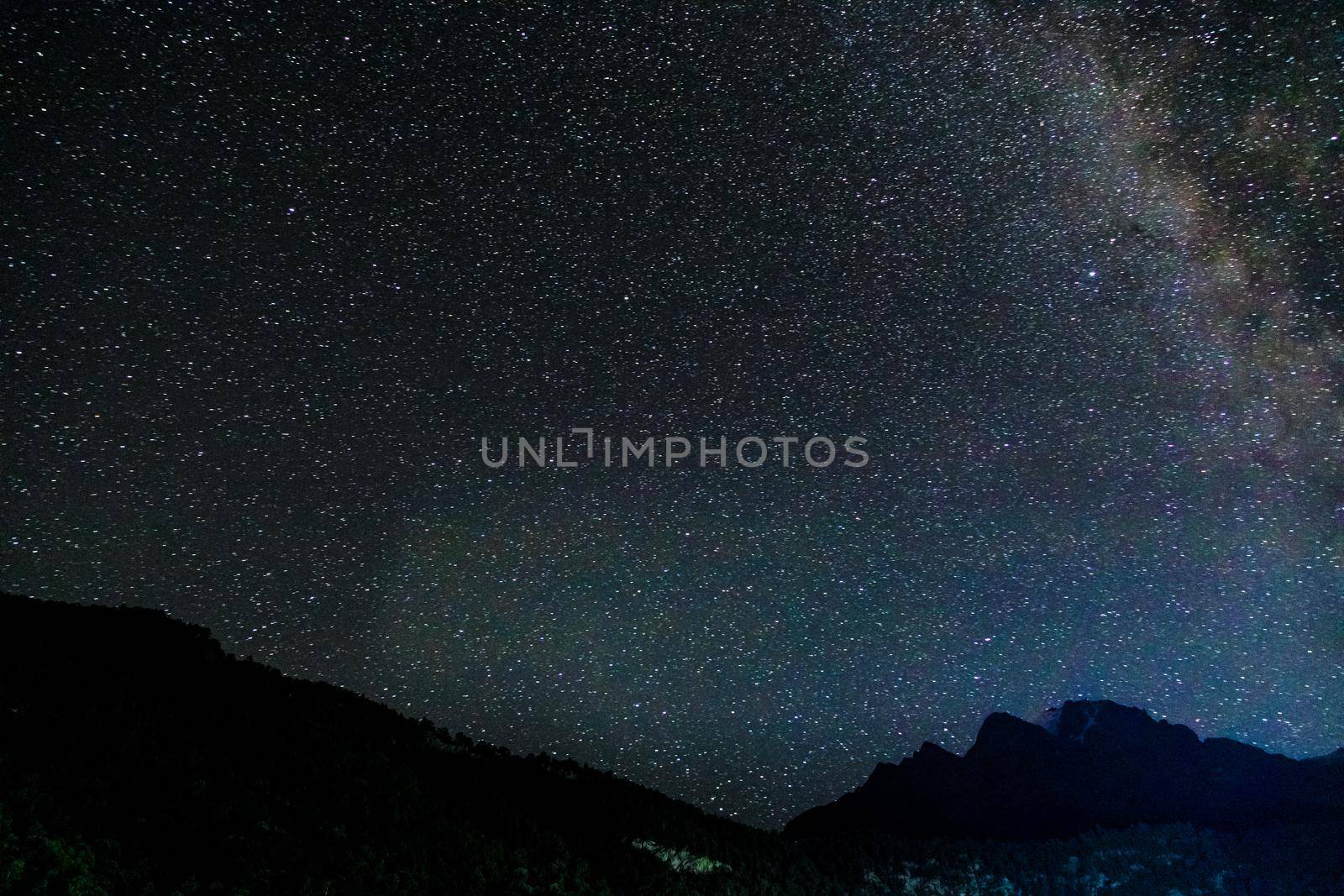 Starry sky and the Milky Way with bright stars over the mountains of North Ossetia.