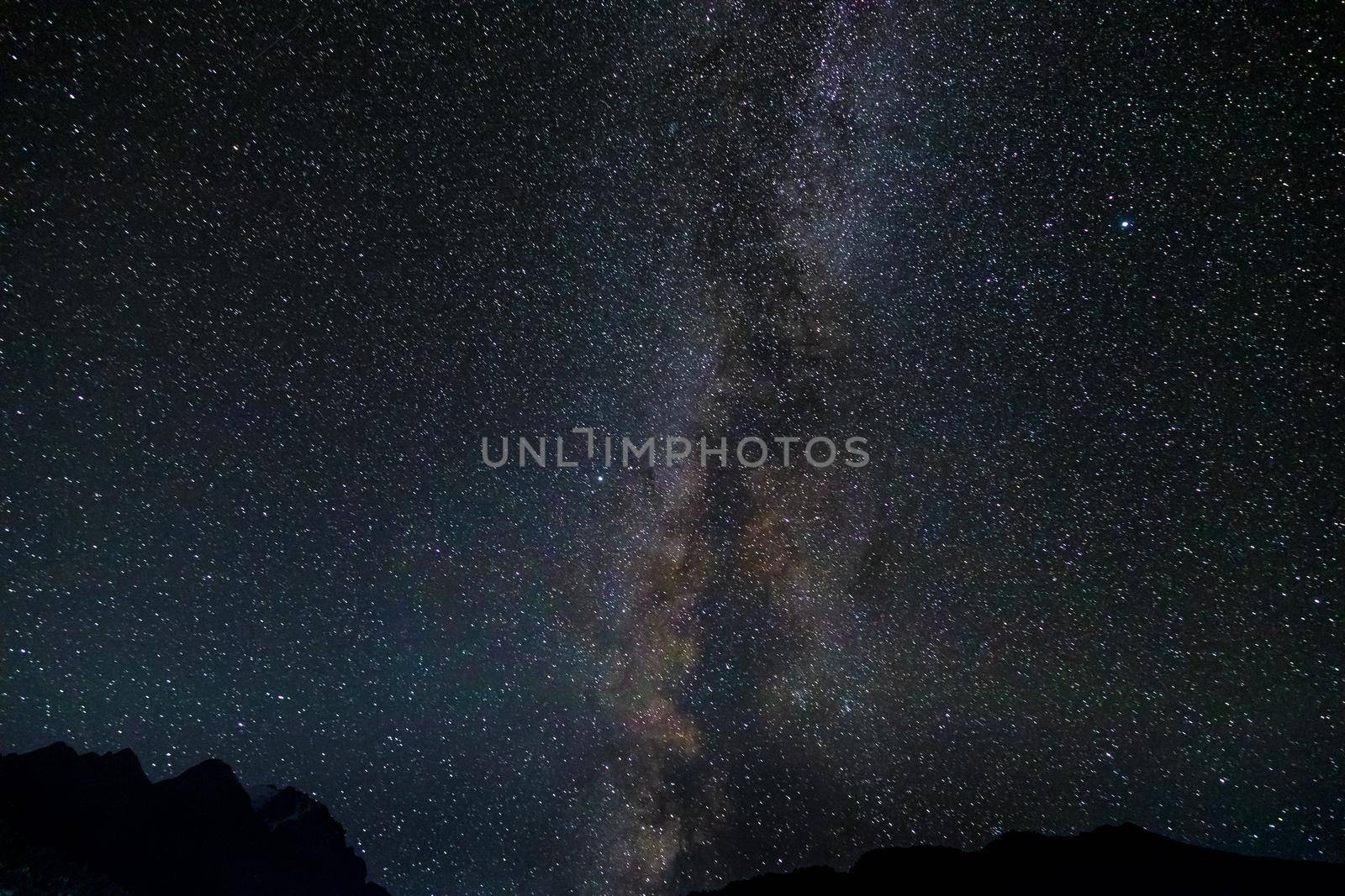 Starry sky and the Milky Way with bright stars over the mountains of North Ossetia.