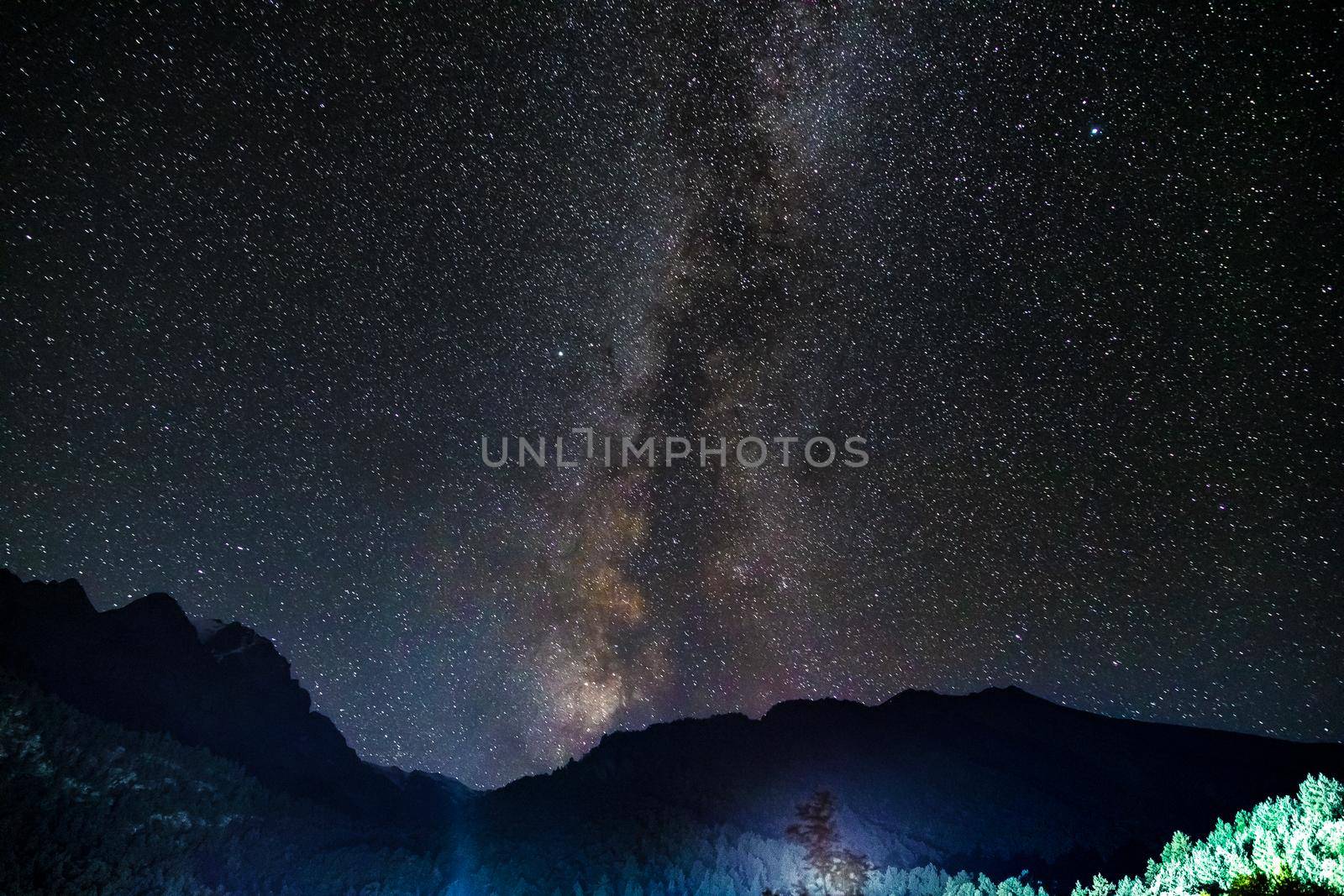 Starry sky and the Milky Way with bright stars over the mountains of North Ossetia.