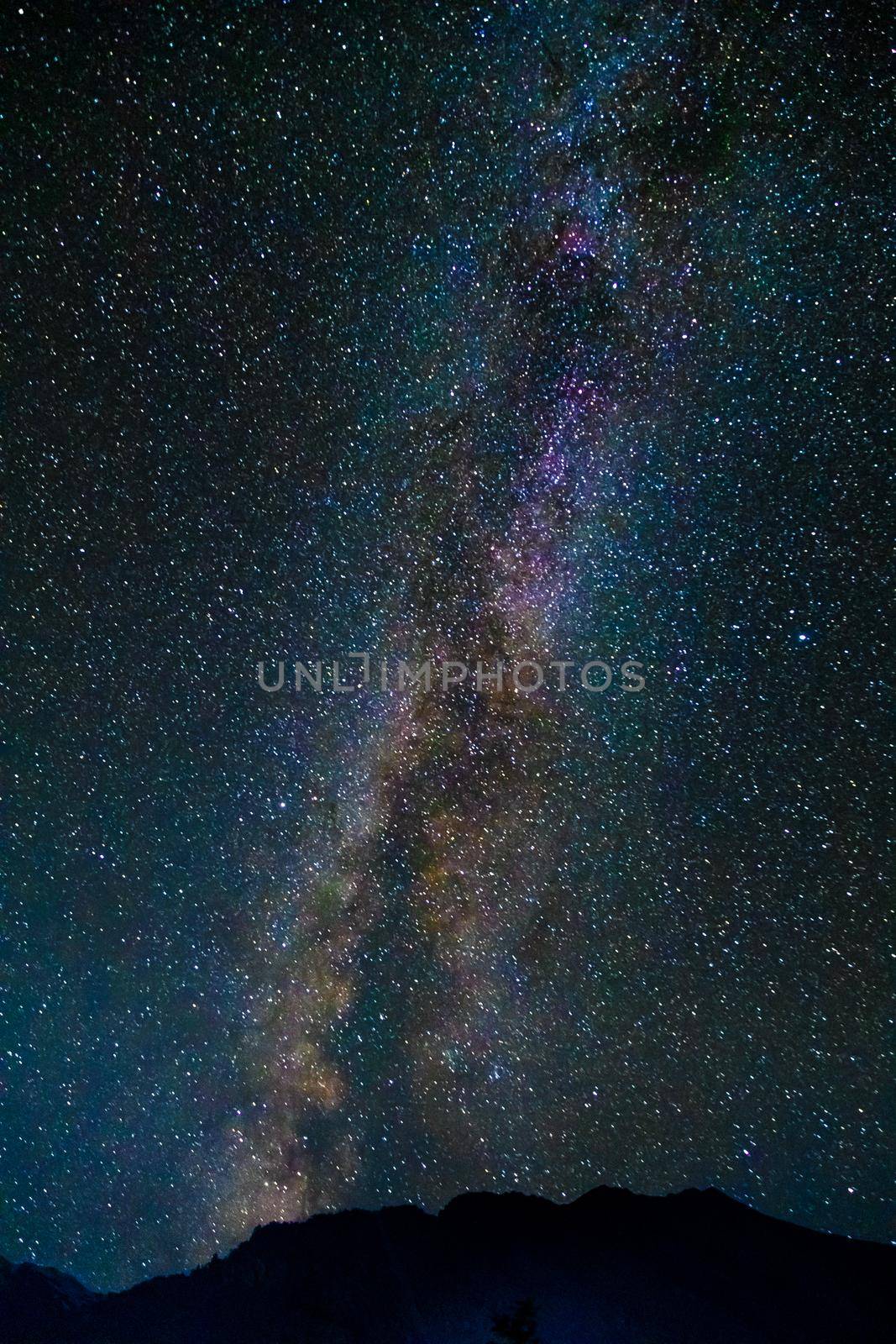 Starry sky and the Milky Way with bright stars over the mountains of North Ossetia.