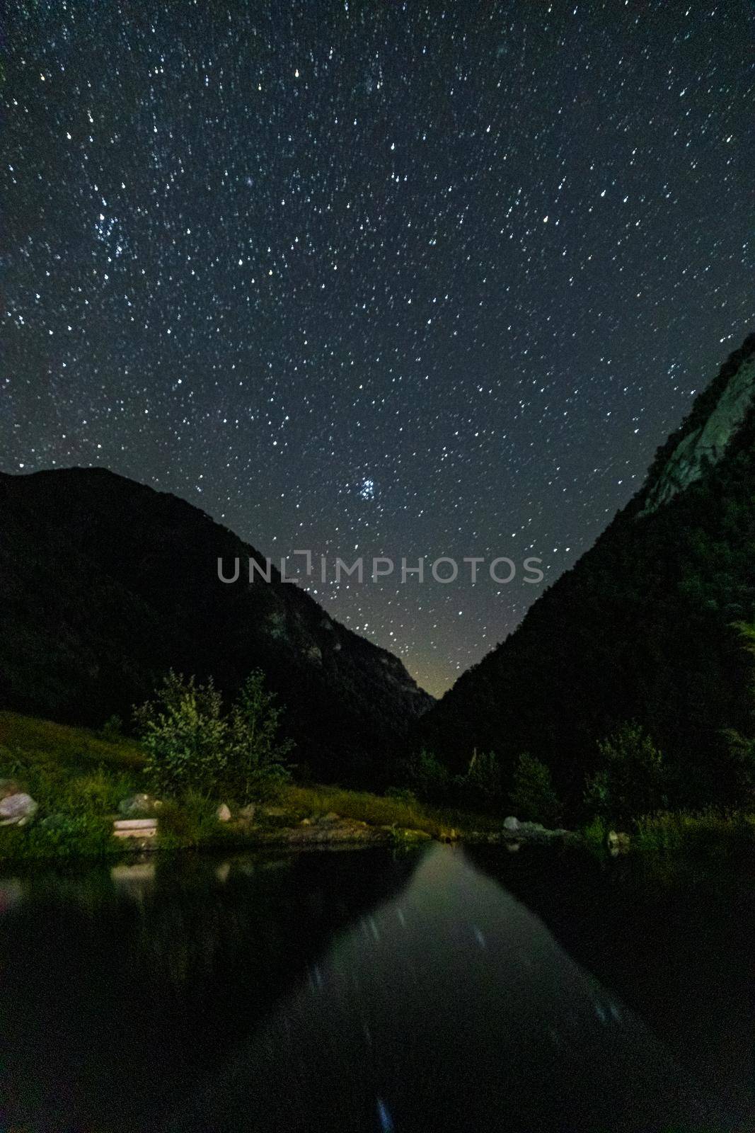 Starry sky and the Milky Way with bright stars over the mountains of North Ossetia.