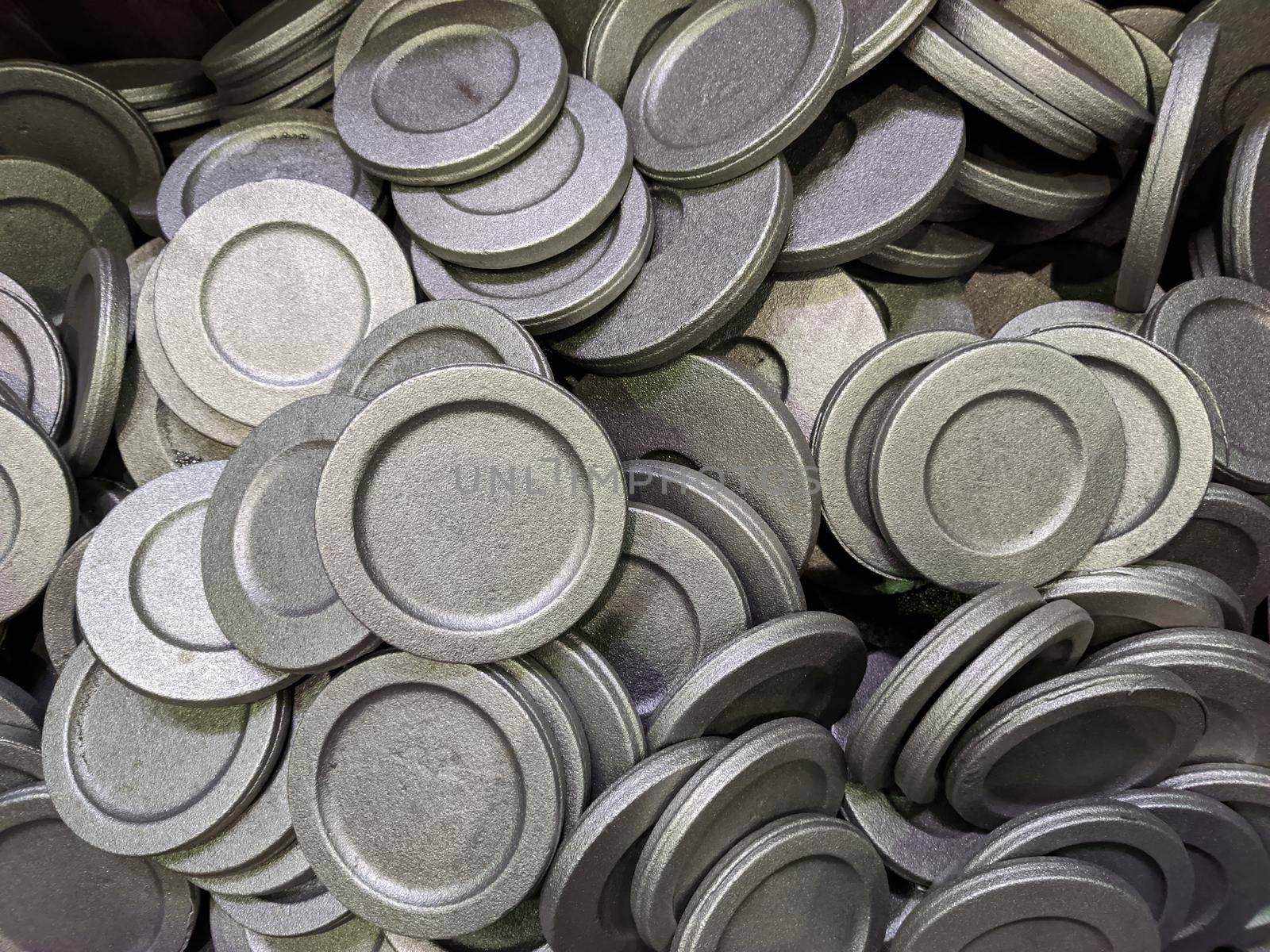 full frame pile of gray steel forgings after shot blasting - close-up natural heavy industrial pattern with selective focus.