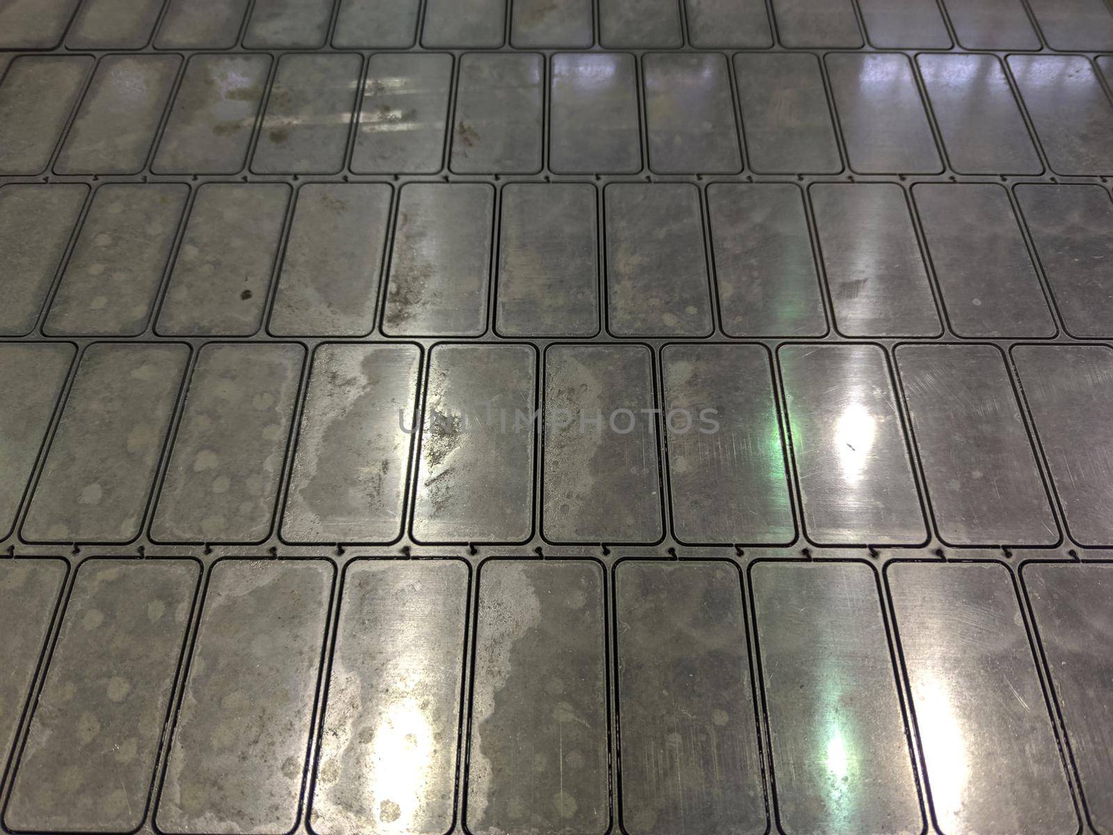 full frame background of waterjet cutted parts in steel sheet.