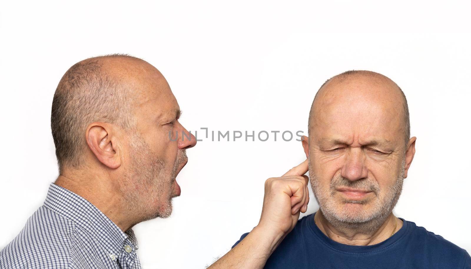 a man screaming in the ear. Concept of his ego screaming inside themselves