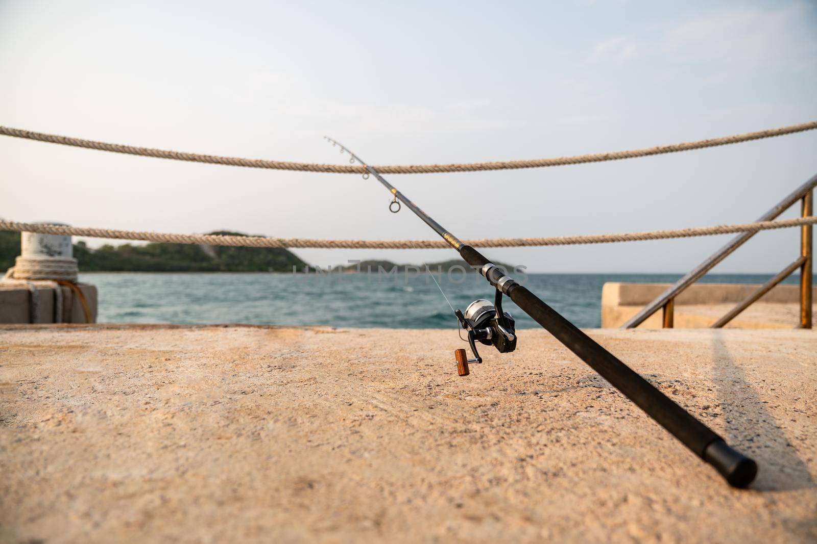 A fishing rod with sea background, fishing.