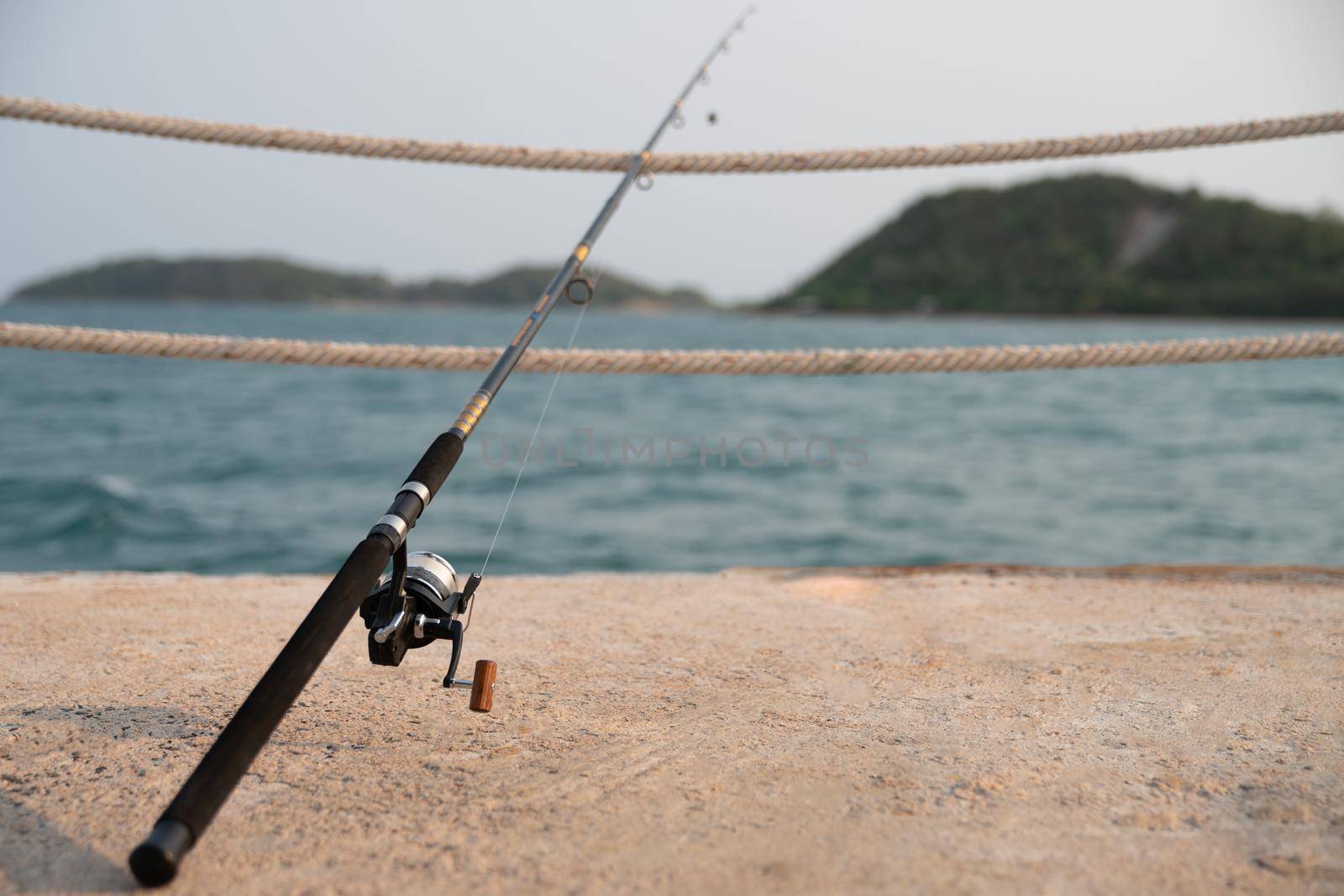 A fishing rod with sea background, fishing.