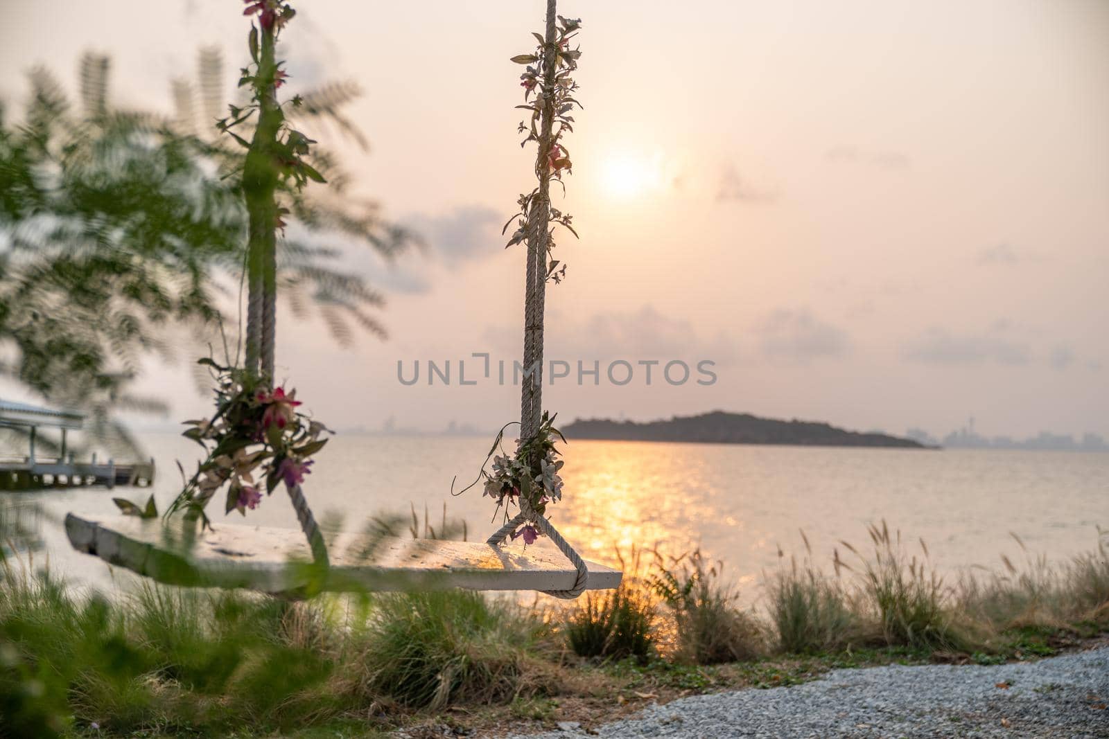 The wooden swing by the sea, sunset. by sirawit99