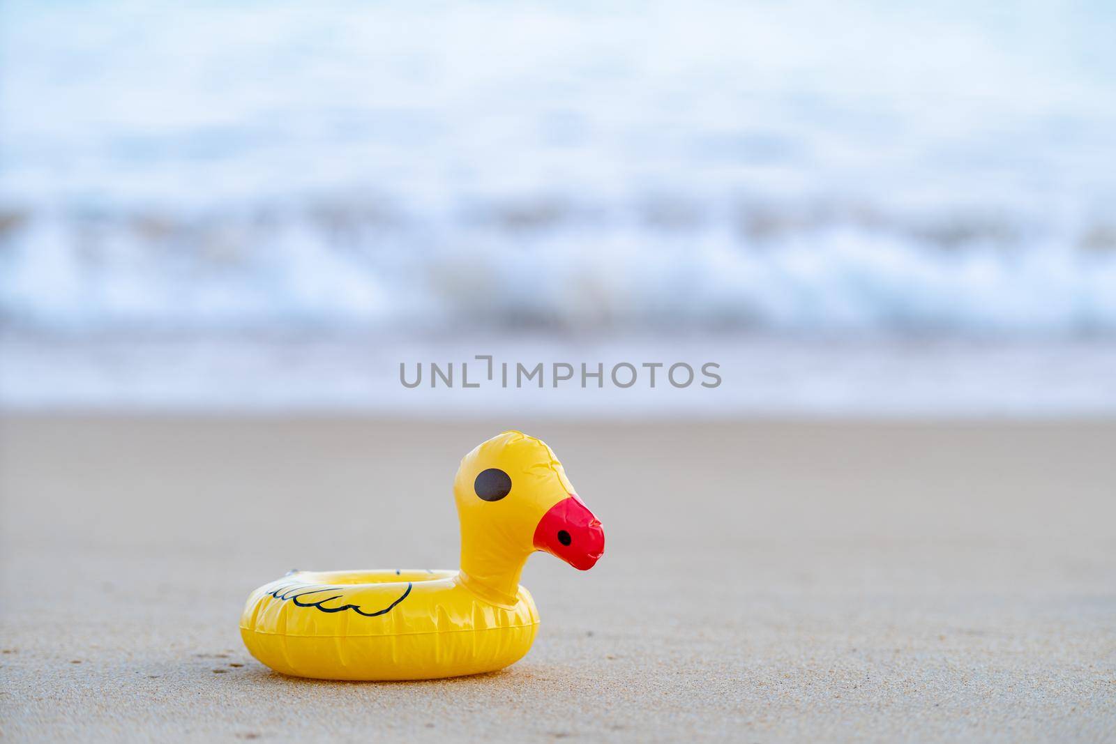 Yellow rubber duck on the seashore in the morning, sand beach. by sirawit99