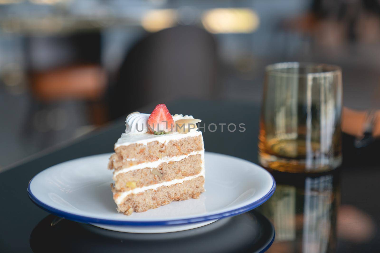 Carrot cake with strawberries topping on table. by sirawit99