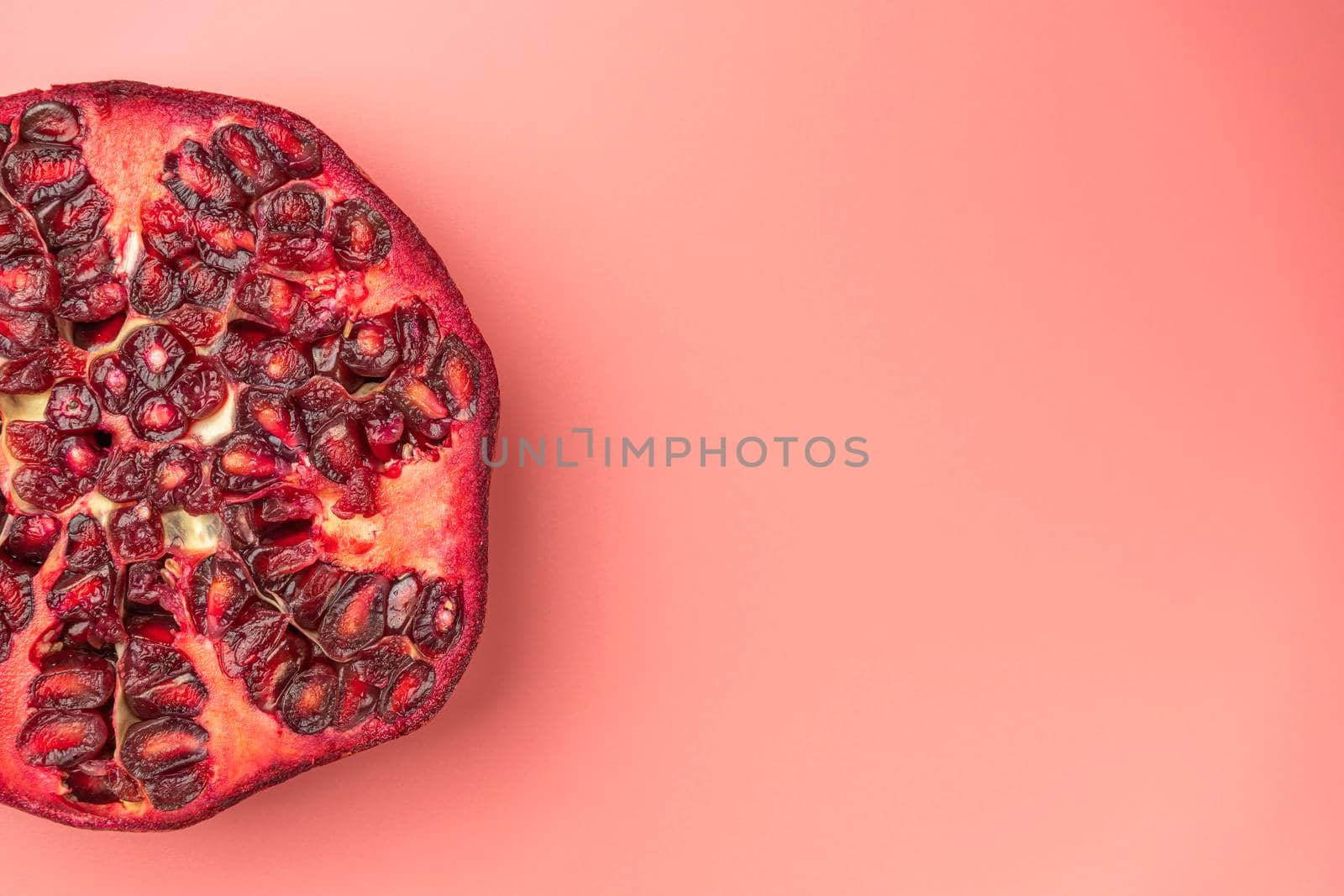 ripe pomegranate on a pink background. love. Fruit. High quality photo