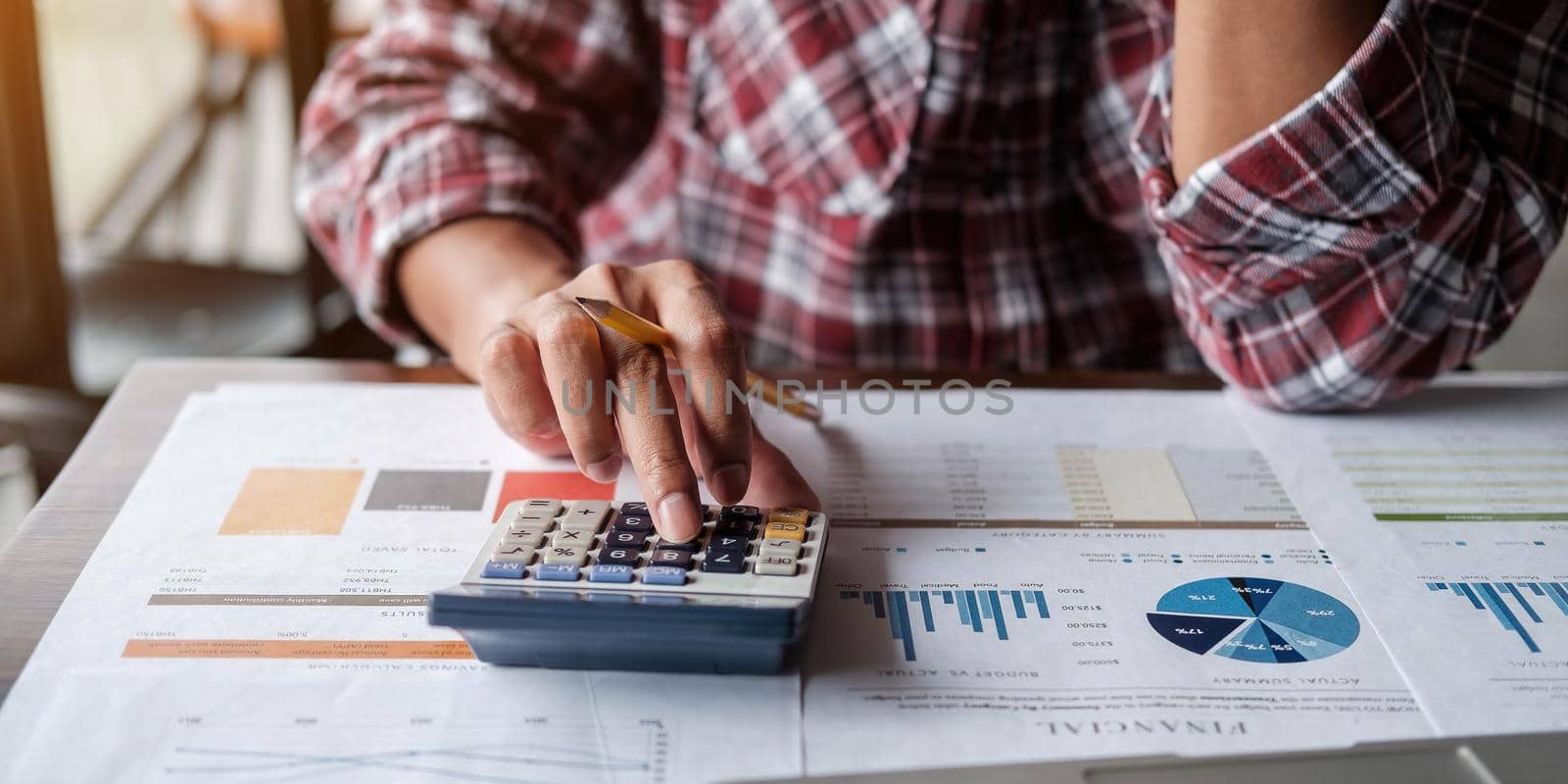 Close up accountant or financial expert analyze business report graph and finance chart at corporate office. Concept of finance economy, banking business and stock market research by wichayada