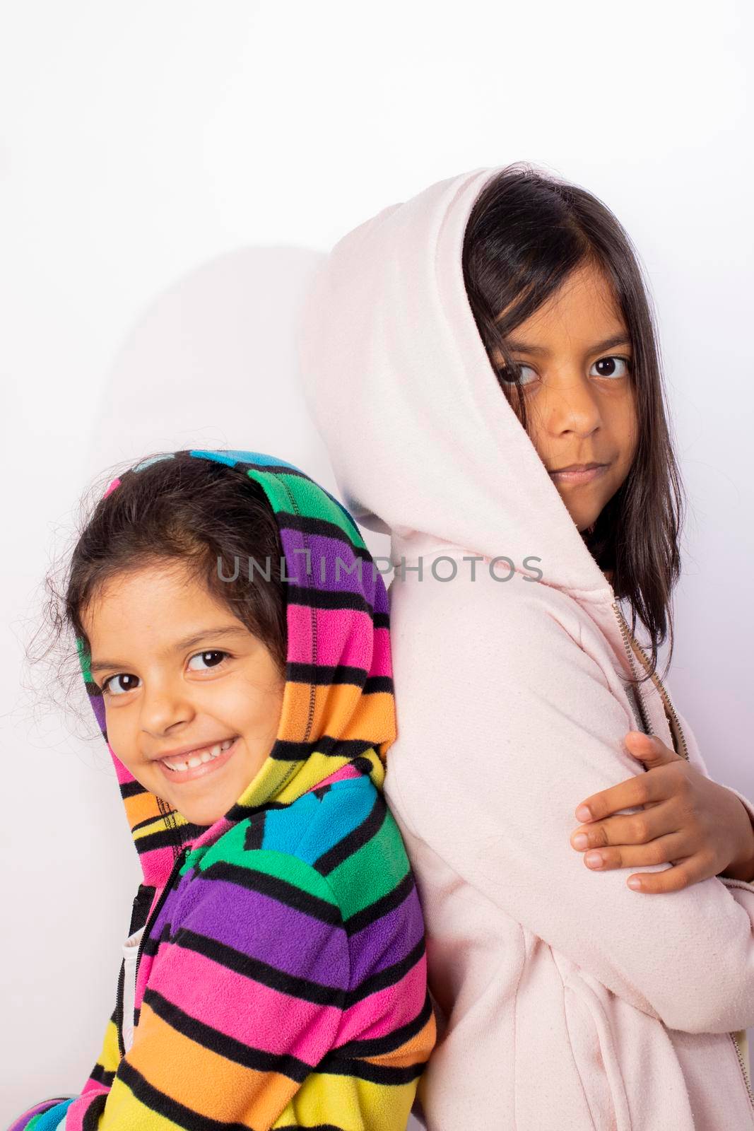 Portrait of little sisters wearing hooded sweater