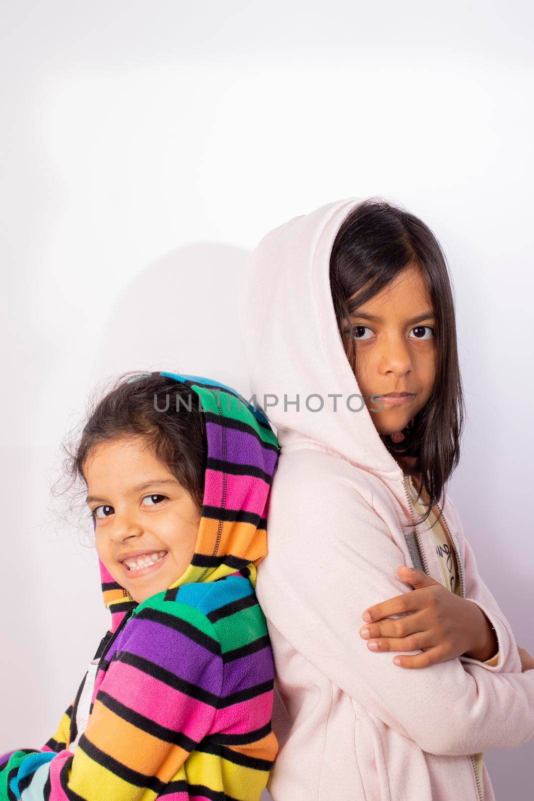 Portrait of little sisters wearing hooded sweater by eagg13
