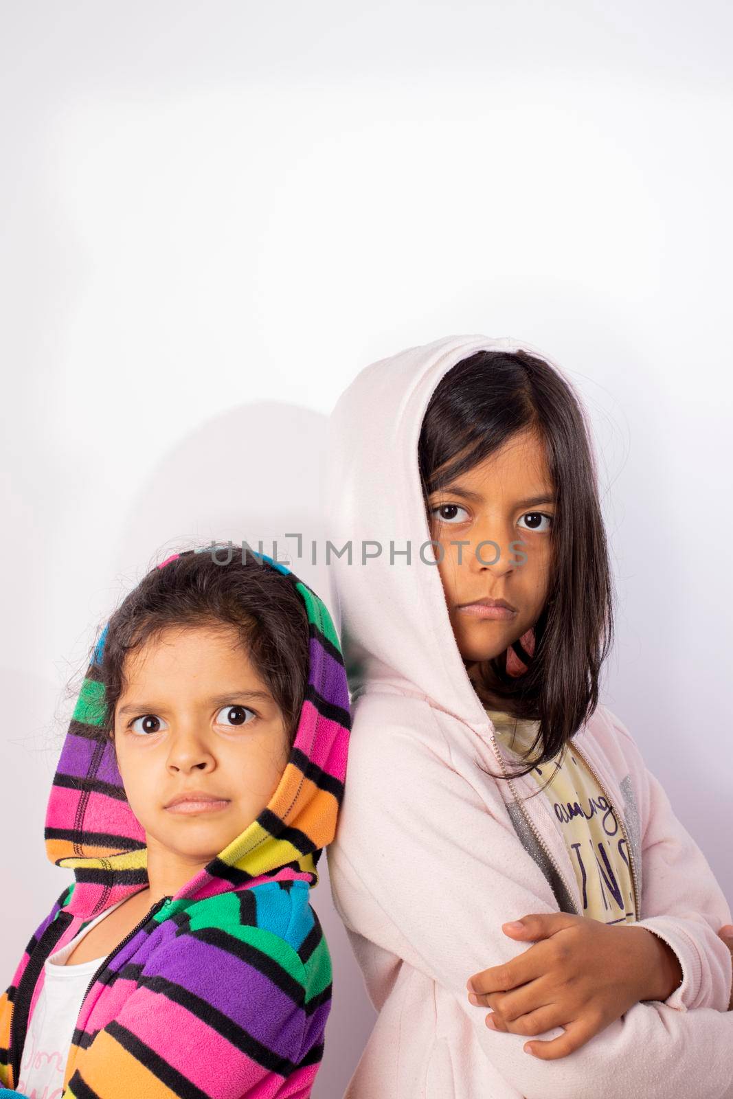Portrait of little sisters wearing hooded sweater by eagg13