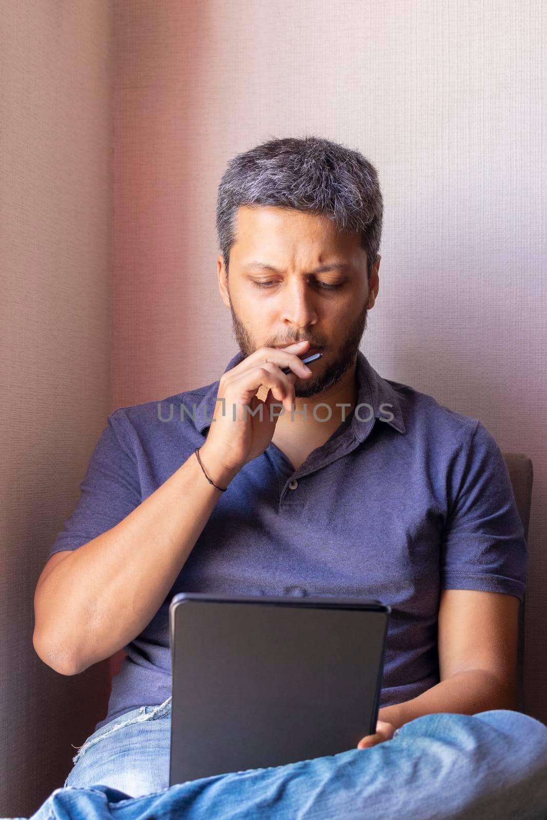 Handsome man working at home with his tablet