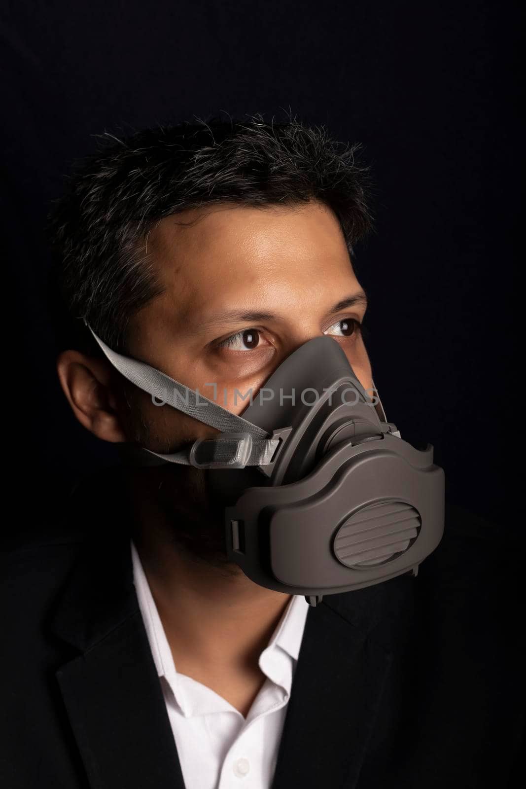 Young handsome with industrial mask to prevent the spread of contagious viruses or chemical gases by eagg13