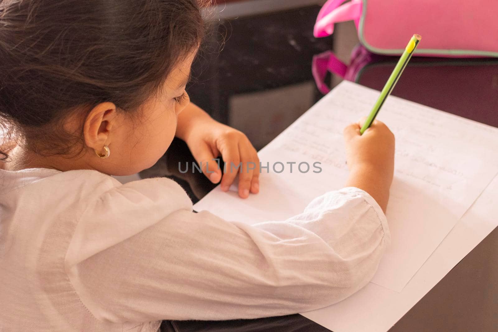 Girl is writting at a small table by eagg13