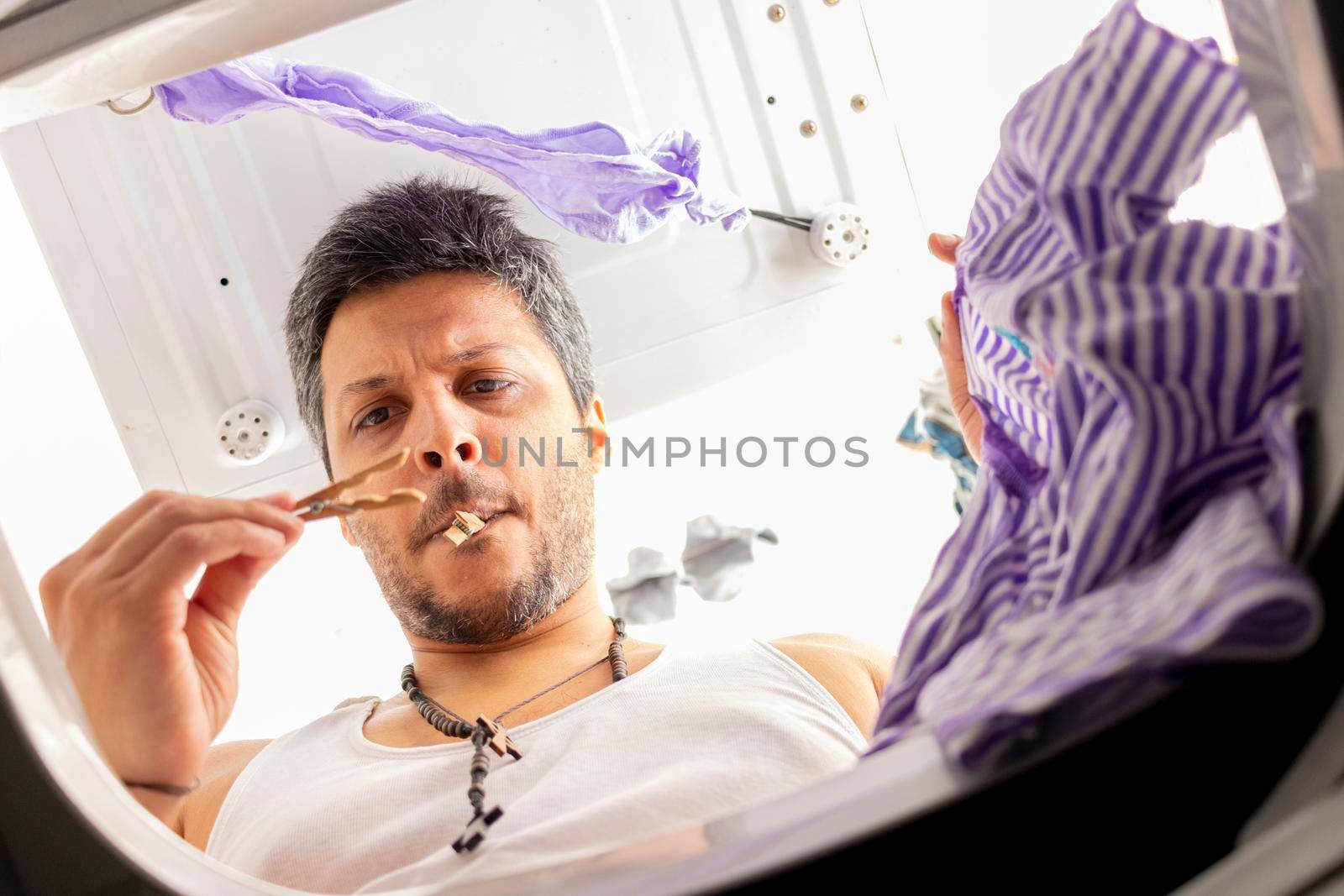 Bearded man using washing machine at home