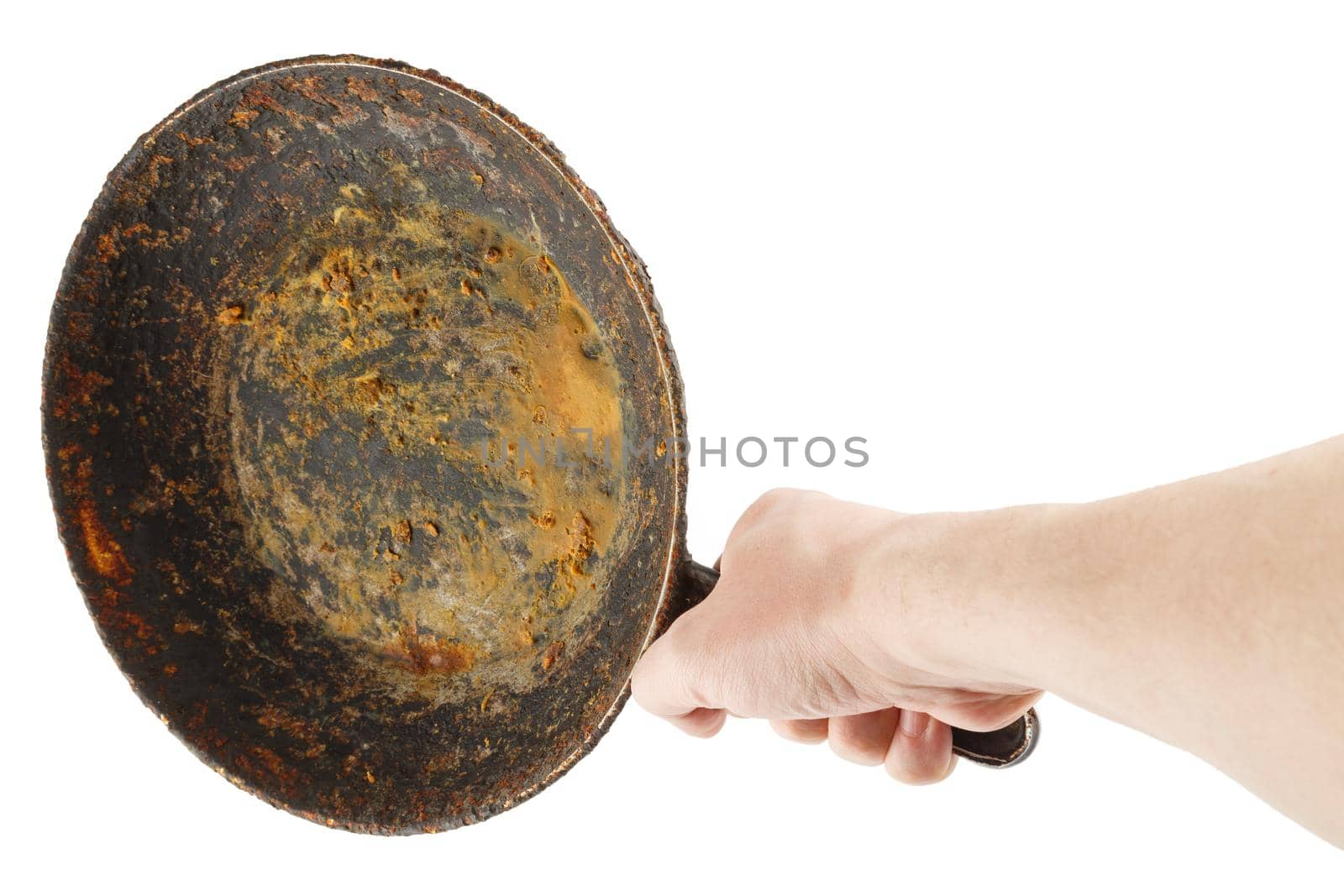 bare caucasian hand holding empty old cast iron frying pan - isolated on white background