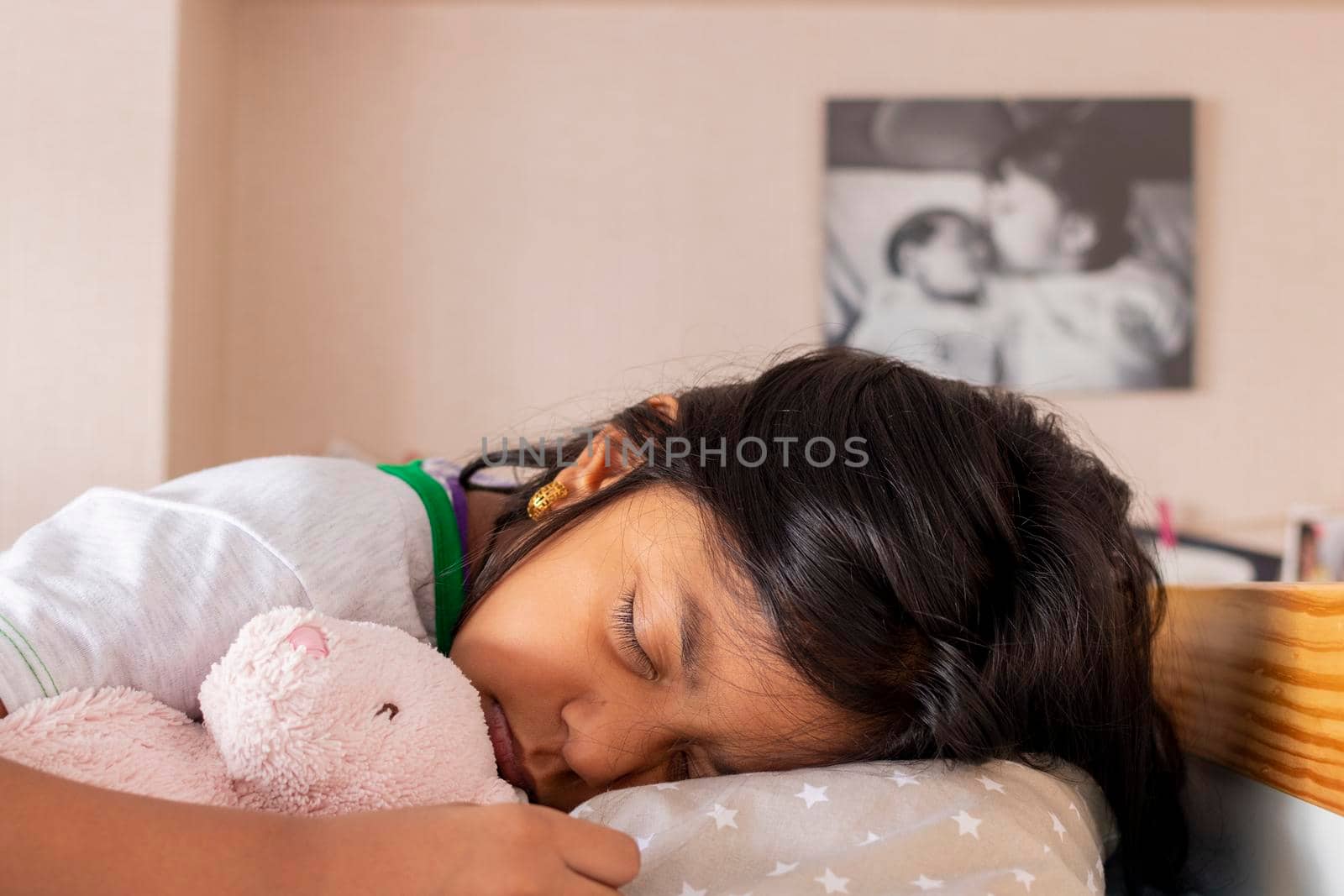 Little girl sleeping on her bed inside her room
