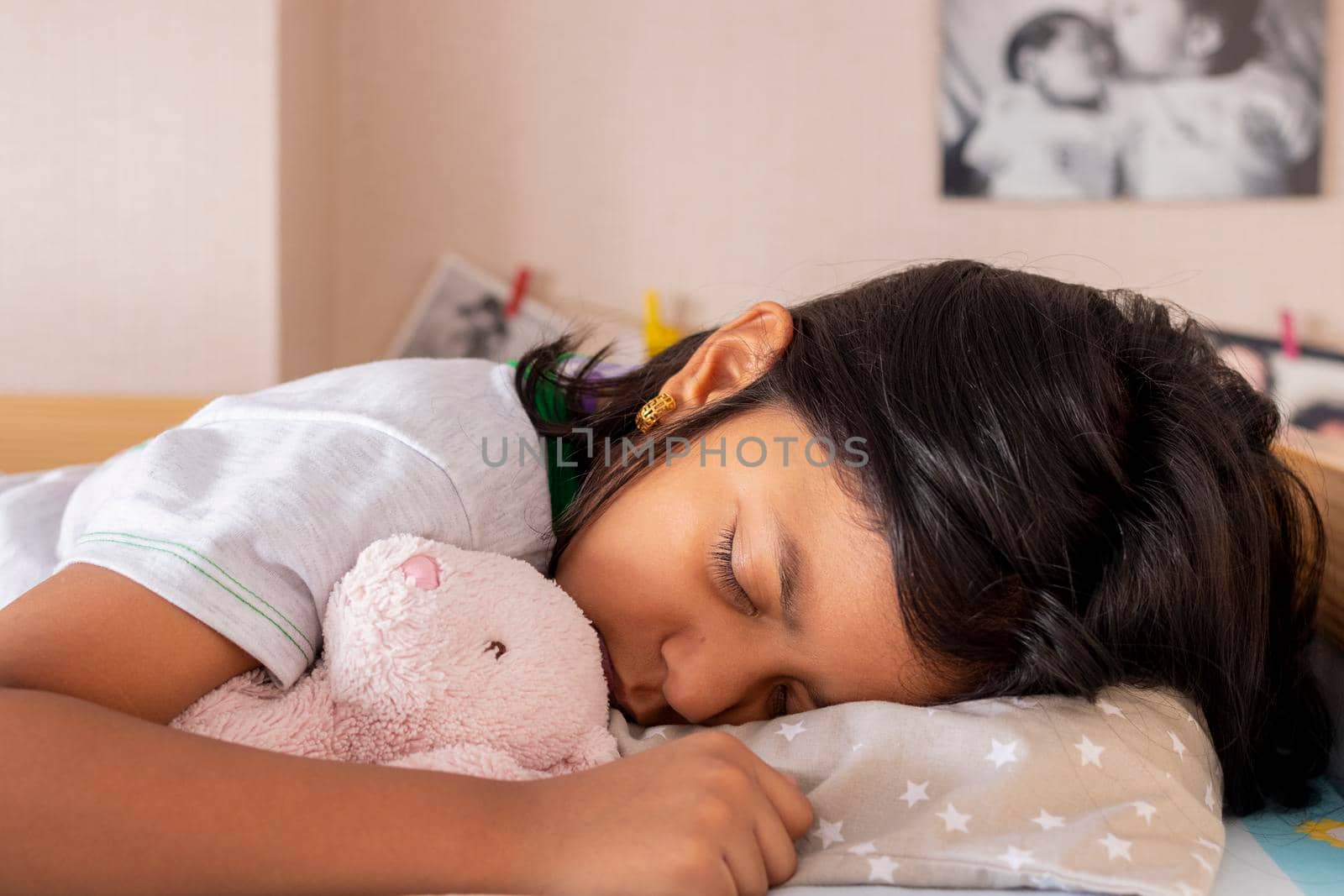 Little girl sleeping on her bed inside her room