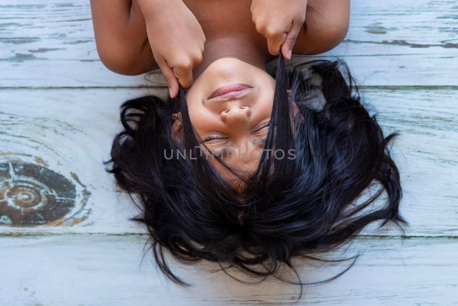 Close up of brunette teenager touching her face with her hands by eagg13